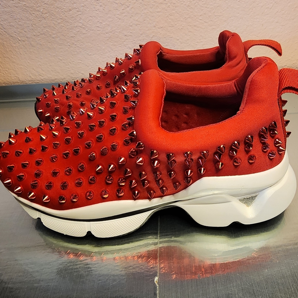 Red spike slip on sneakers size 7.5